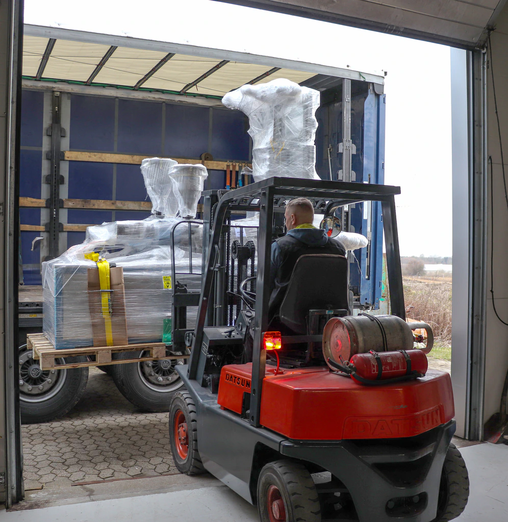 Green Extrusion Technology machine being loaded for international shipment from Denmark