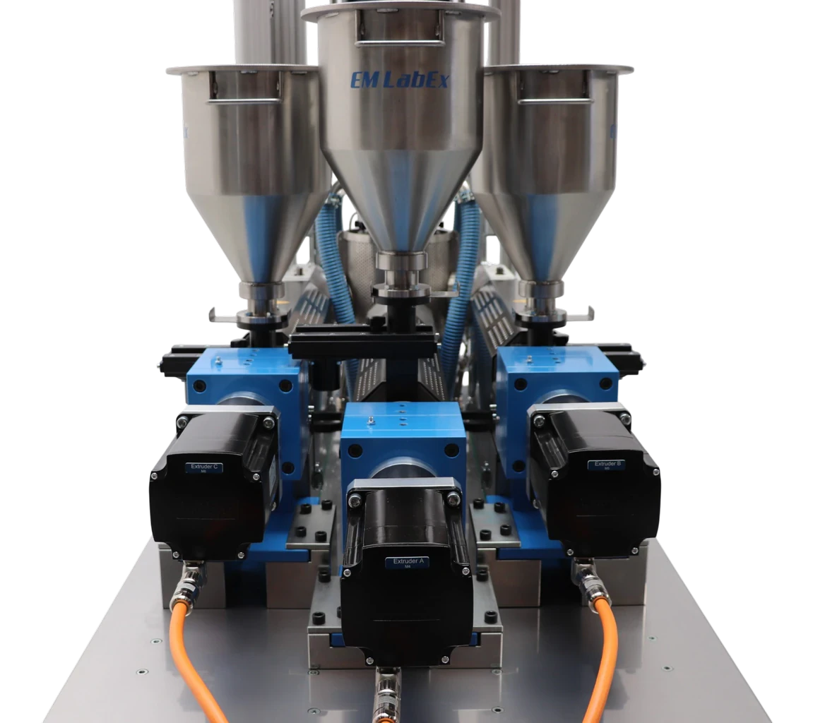 Back view of the LabEx 25-3 showing three independent extruders, motors and material hoppers