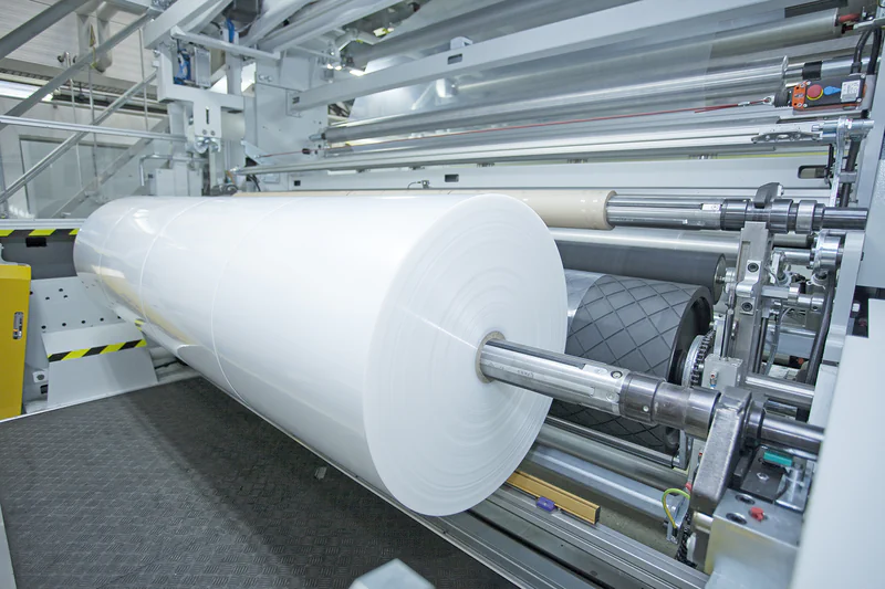 Blown film winder for finished lay-flat film rolls