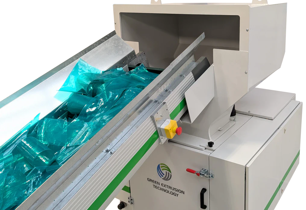 Green Extrusion Technology GRAN 1 granulator with conveyor feeding plastic film waste into the cutting chamber
